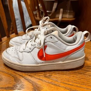 Kids orange and white Nikes